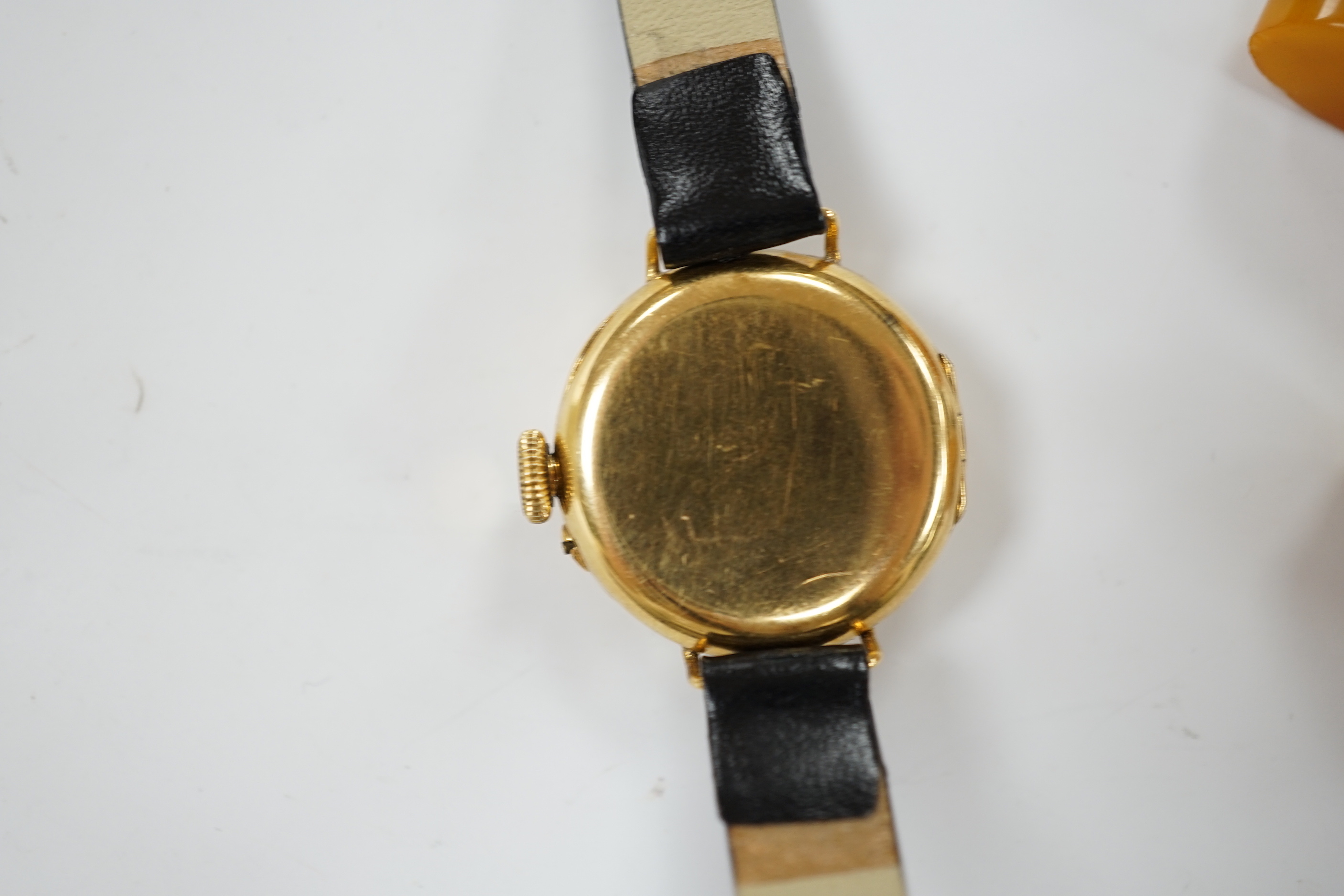A lady's George V 18ct gold manual wind wrist watch, on later associated leather strap, case hallmarked for London, 1916, together with a pair of amber set gold plated cufflinks.